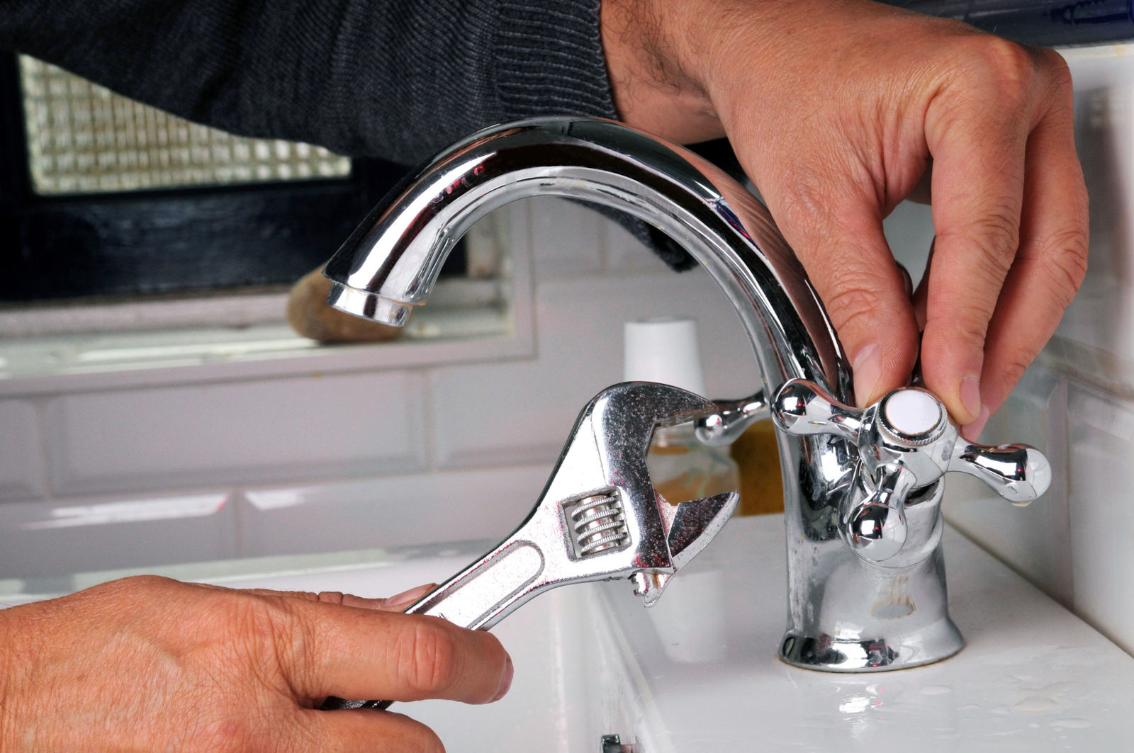 Technician performing a precise faucet repair installation